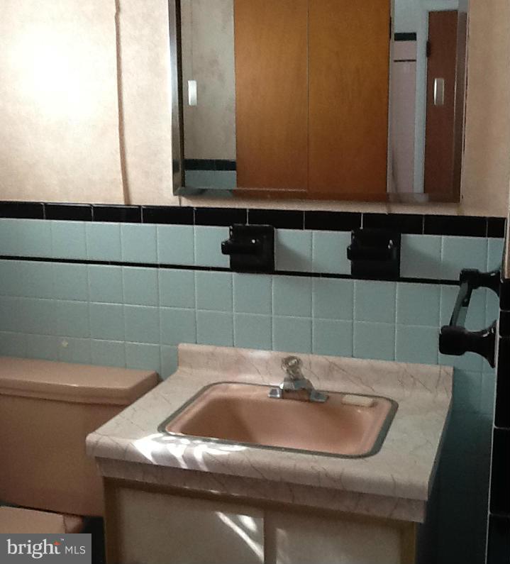 3312 Croydon Road Baltimore, MD 21207 - Photo 16 of 22 a bathroom with a sink and a mirror