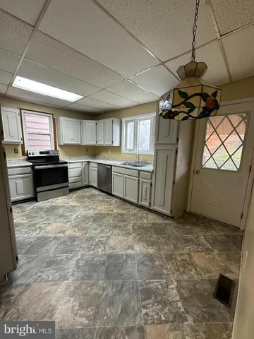 a kitchen with refrigerator and window
