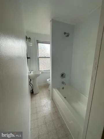 a bathroom with a bathtub and toilet