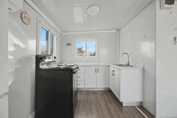 a kitchen with stainless steel appliances granite countertop a stove a sink and a microwave