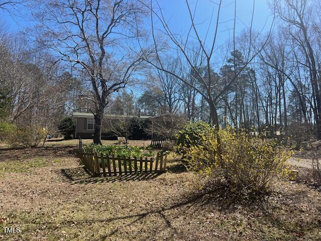 887 Bish Road Staley, NC 27355 - Photo 1 of 17 a view of a yard with plants and trees