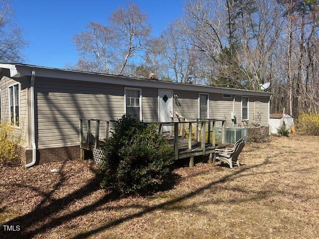 887 Bish Road Staley, NC 27355 - Photo 2 of 17 a view of backyard with a table and chairs and wooden fence