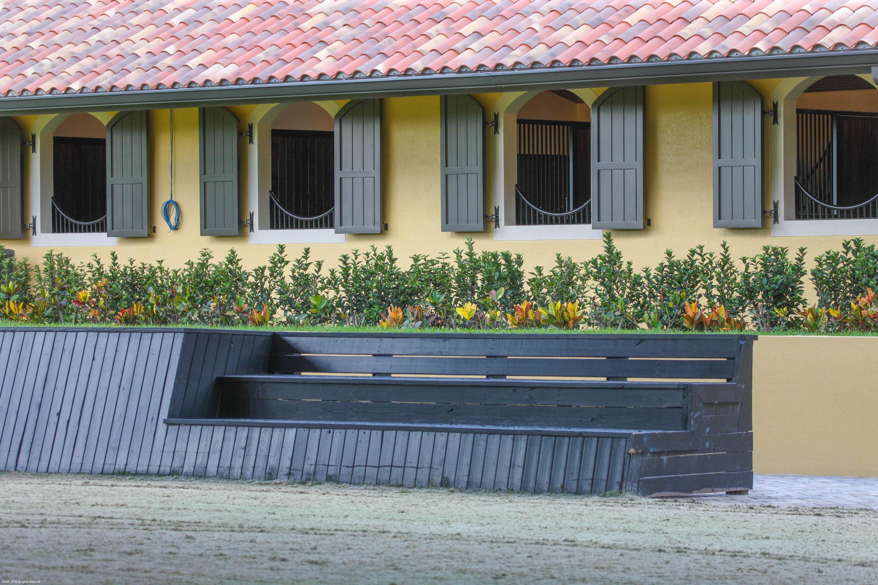 4985 Stables Way Wellington, FL 33414 - Photo 21 of 79 a front view of a house with a yard