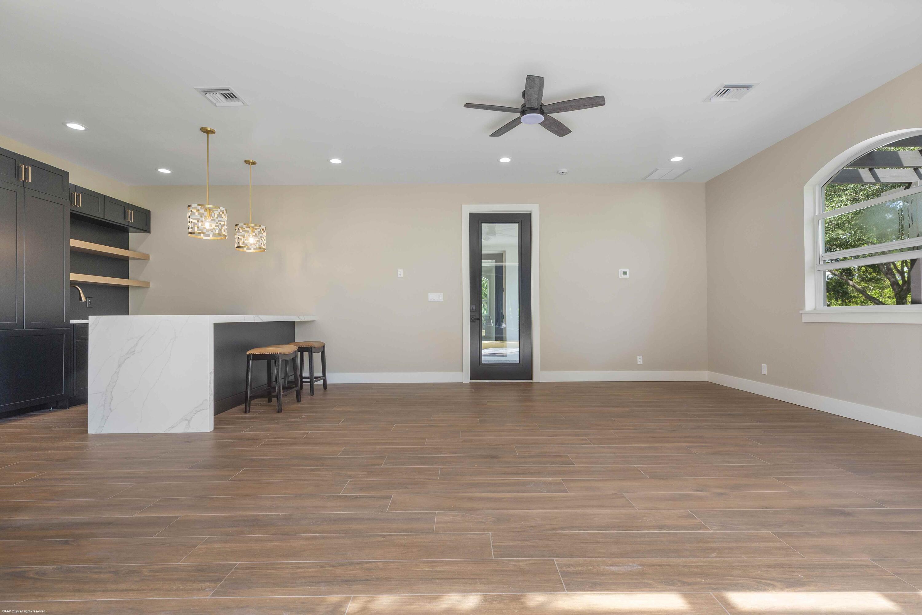 4985 Stables Way Wellington, FL 33414 - Photo 34 of 79 a view of a livingroom with furniture nad wooden floor