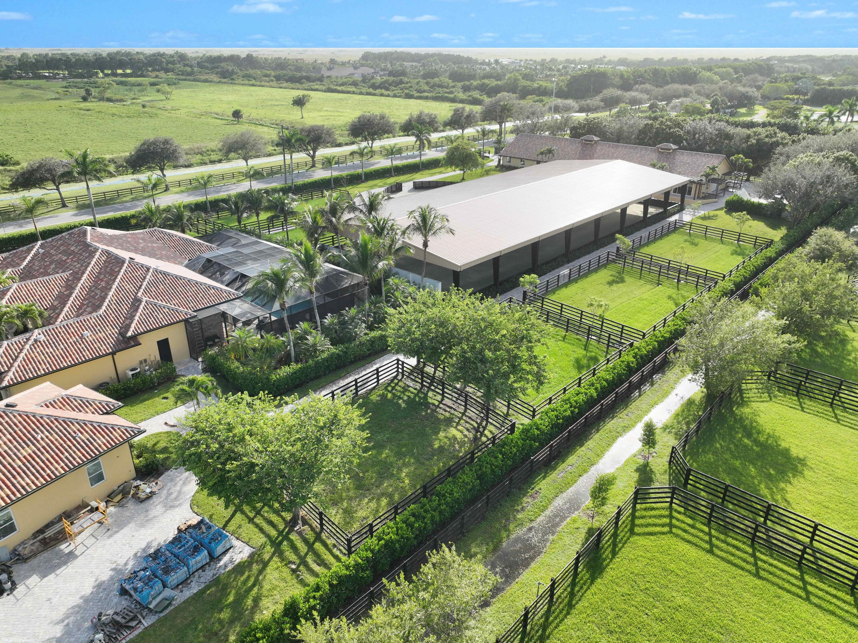 4985 Stables Way Wellington, FL 33414 - Photo 72 of 79 an aerial view of residential houses with outdoor space and river