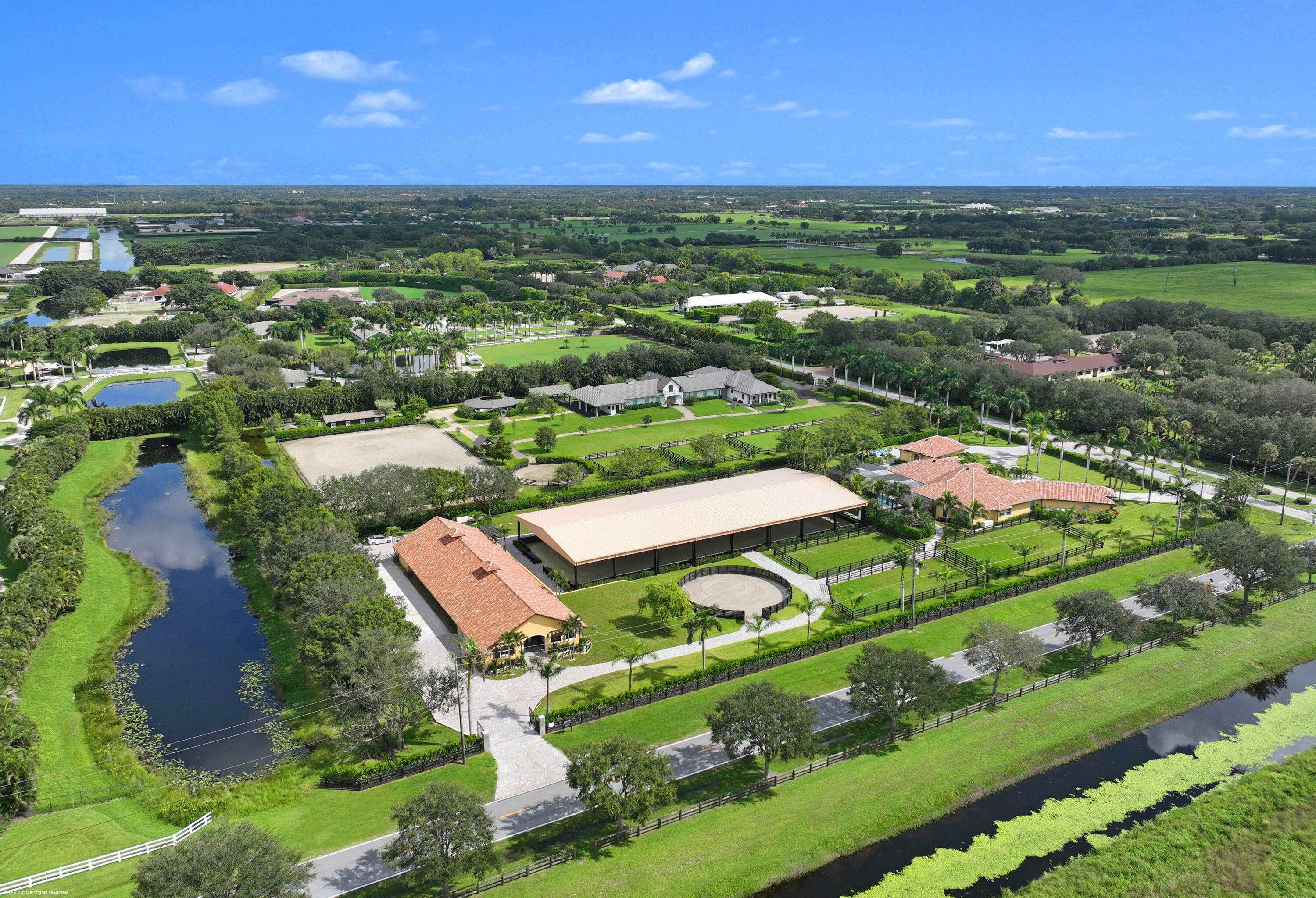 4985 Stables Way Wellington, FL 33414 - Photo 78 of 79 an aerial view of a city with lots of residential buildings ocean and mountain view in back