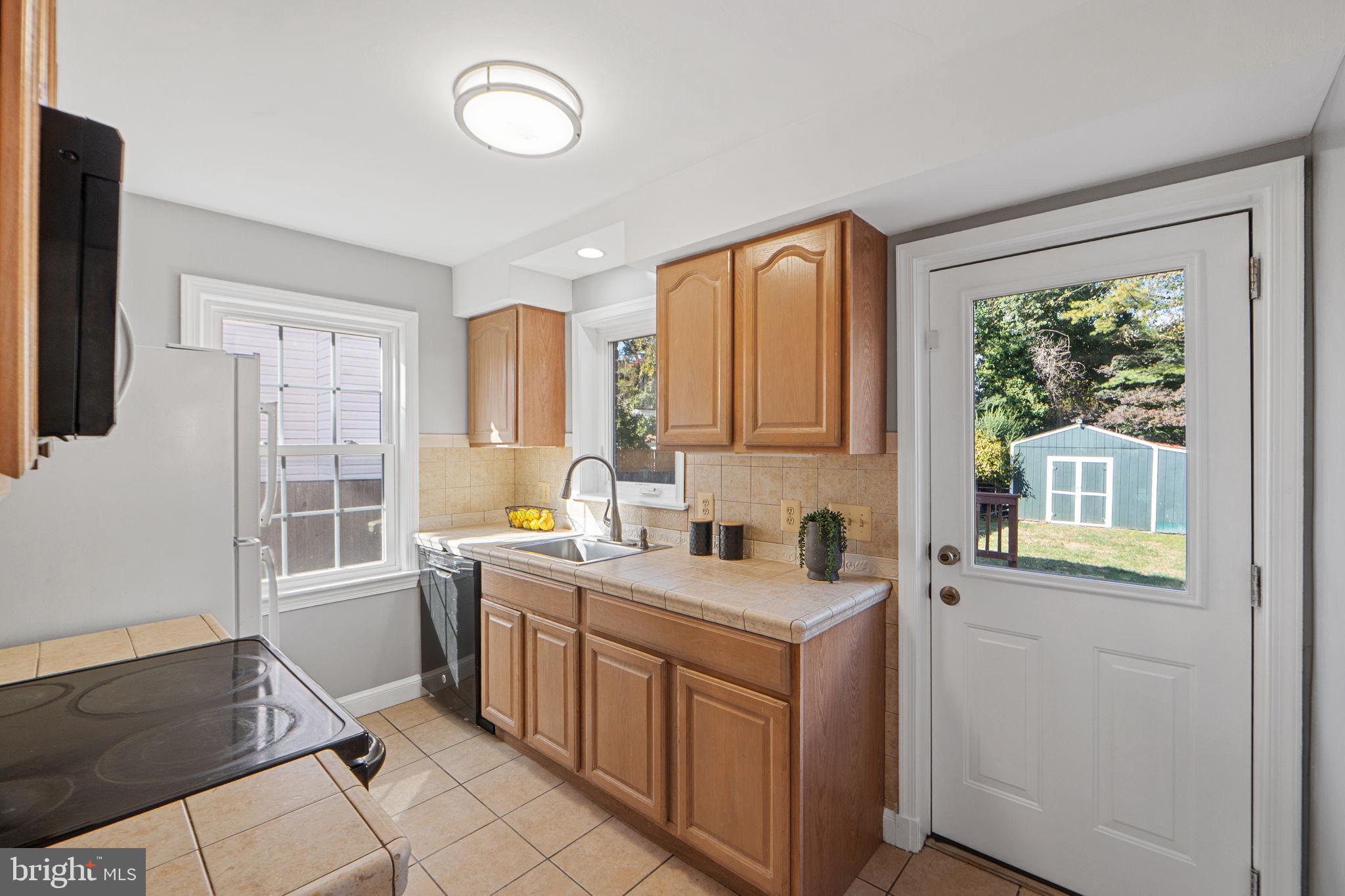 2405 Homestead Drive Silver Spring, MD 20902 - Photo 14 of 43 a kitchen that has a sink and a stove in it