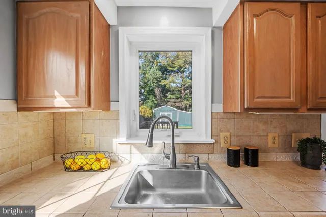 a kitchen with sink a window and cabinets
