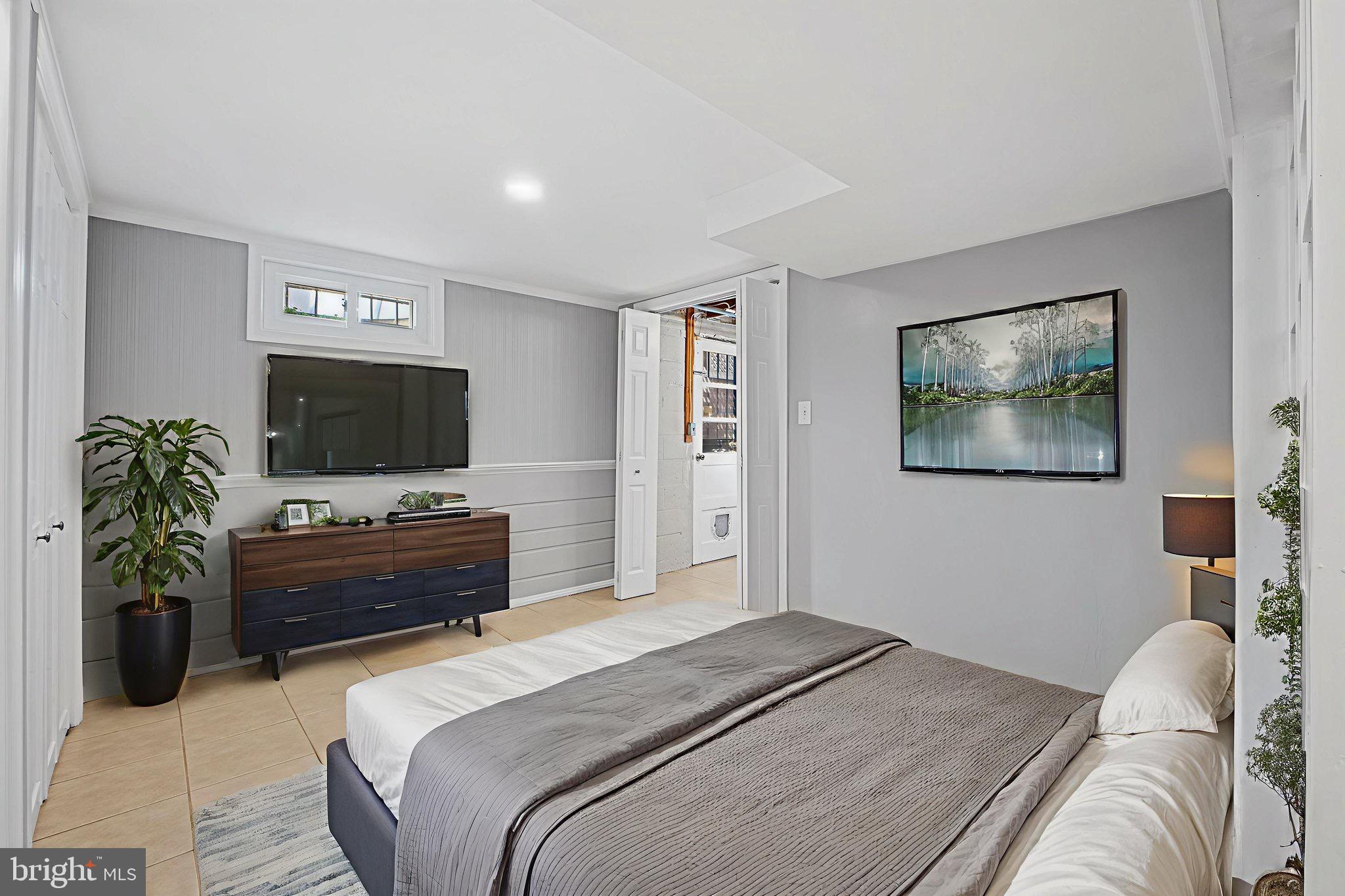 2405 Homestead Drive Silver Spring, MD 20902 - Photo 30 of 43 a bedroom with a bed and a flat screen tv