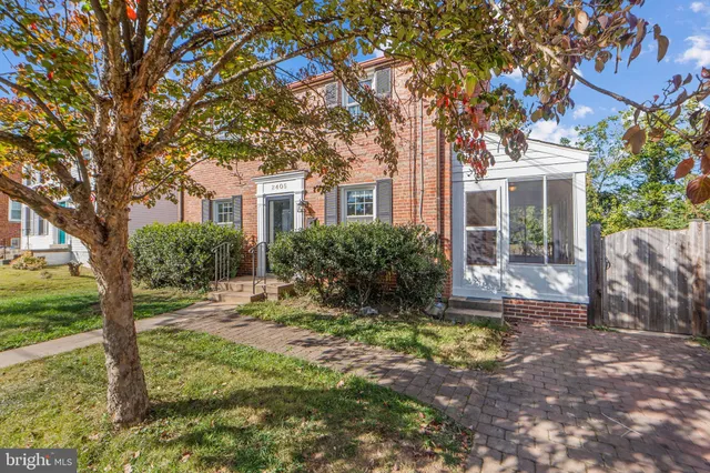 a view of a house with a tree in the yard