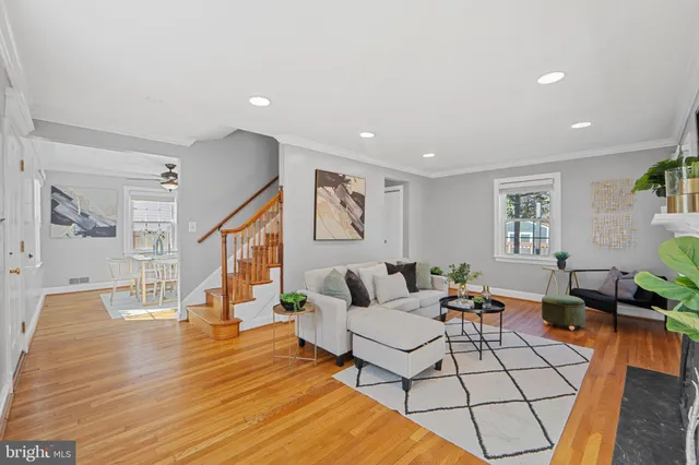 a living room with fireplace furniture and a wooden floor