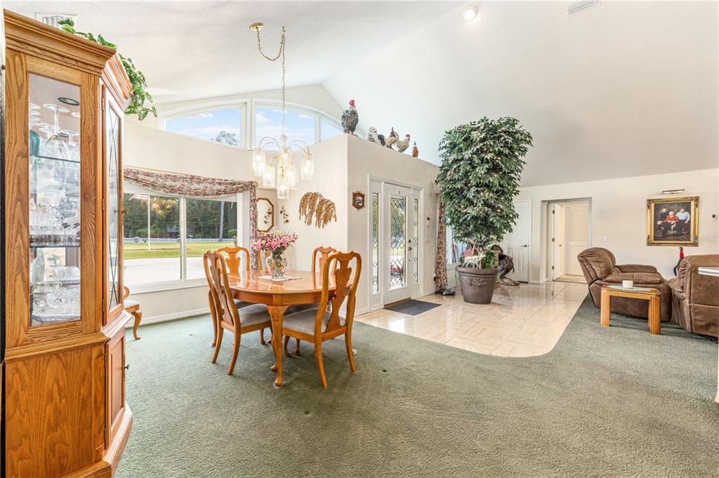 255 Southwest 96th Lane Ocala, FL 34476 - Photo 15 of 87 a dining room with furniture garden view and a chandelier