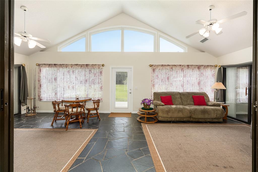 255 Southwest 96th Lane Ocala, FL 34476 - Photo 20 of 87 a living room with furniture and a chandelier