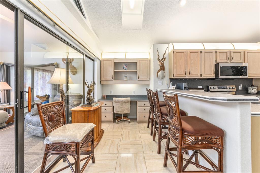 255 Southwest 96th Lane Ocala, FL 34476 - Photo 25 of 92 a kitchen with a table chairs and a refrigerator