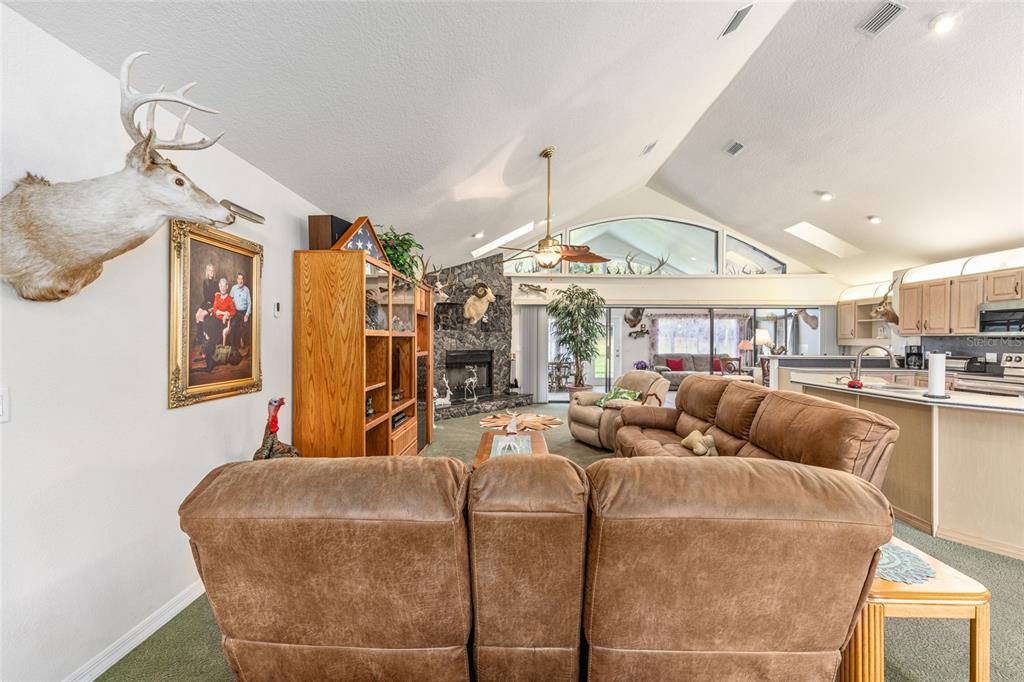 255 Southwest 96th Lane Ocala, FL 34476 - Photo 31 of 92 a living room with furniture a large window and a chandelier