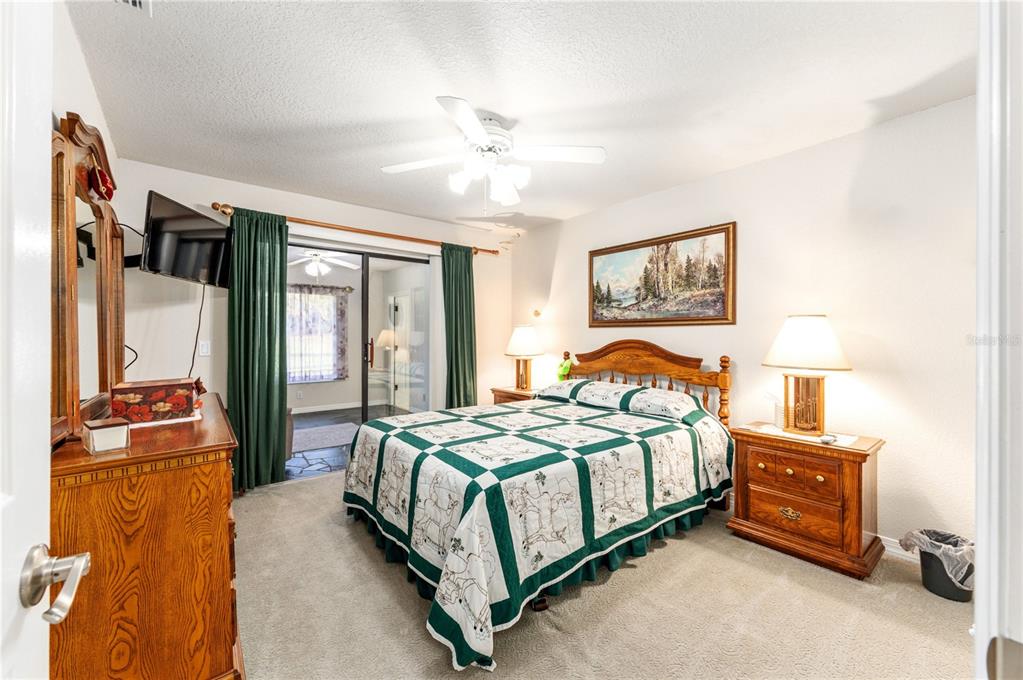 255 Southwest 96th Lane Ocala, FL 34476 - Photo 35 of 87 a bedroom with a bed and a chandelier
