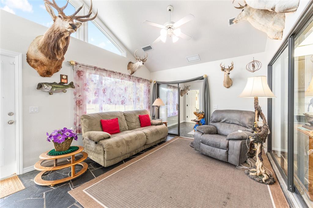 255 Southwest 96th Lane Ocala, FL 34476 - Photo 53 of 92 a living room with furniture and a chandelier