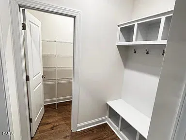 a view of walk in closet with wooden floor