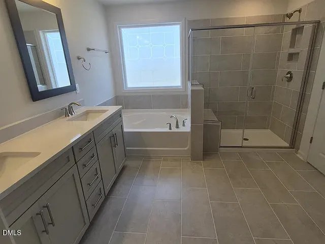a bathroom with a sink a mirror and a bathtub