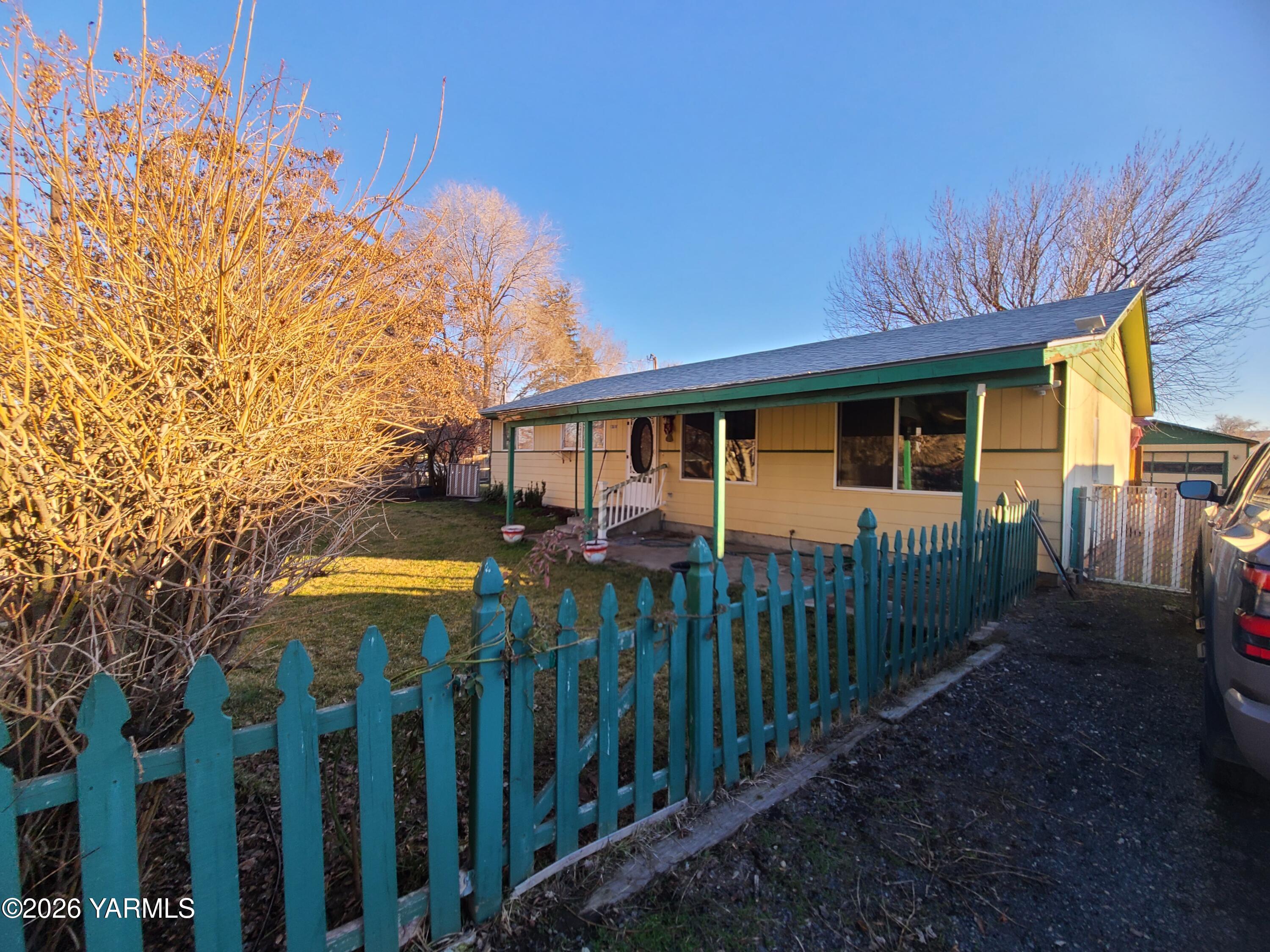 10608 Hackett Road Yakima, WA 98903 - Photo 2 of 25 a view of a house with wooden fence