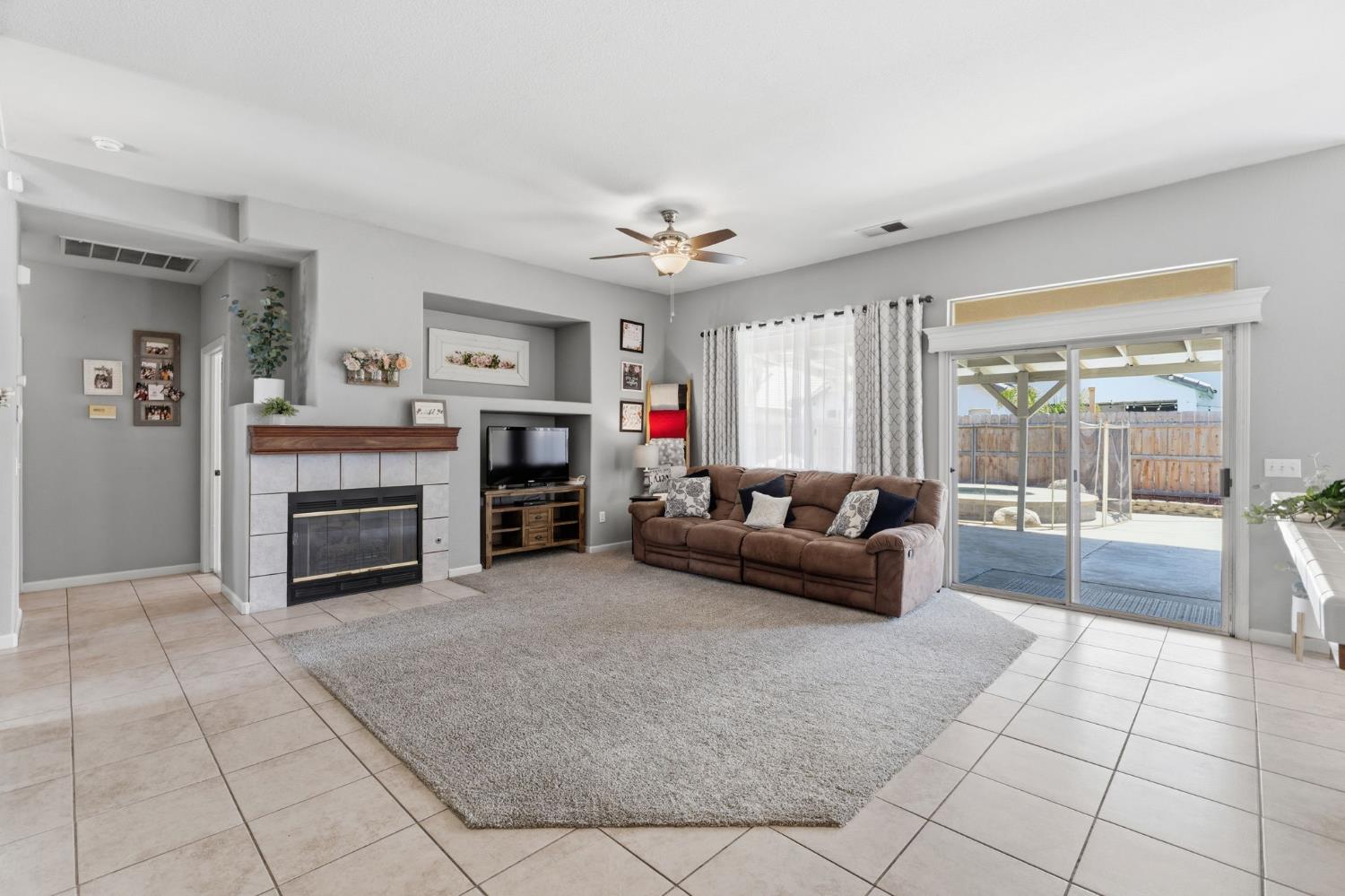 1757 Homestead Way Lemoore, CA 93245 - Photo 5 of 35 a living room with furniture and a fireplace