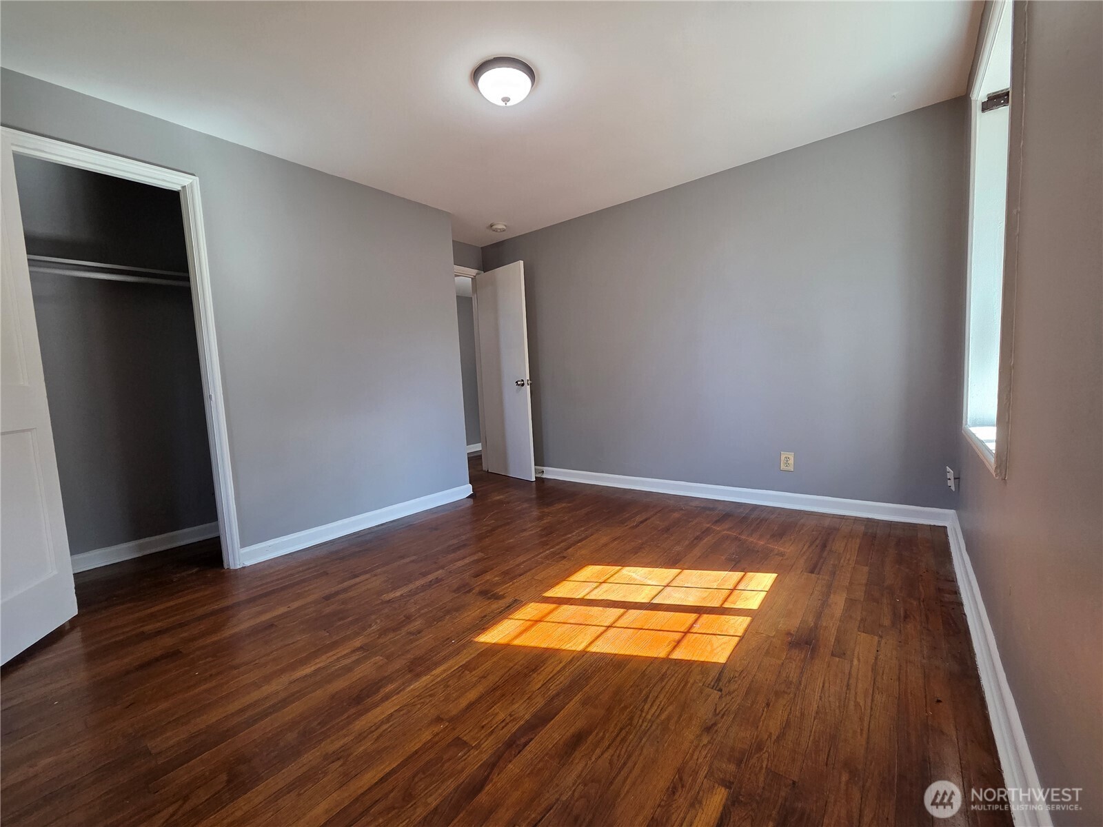 10603 12th Avenue Southwest Seattle, WA 98146 - Photo 11 of 14 an empty room with wooden floor and windows