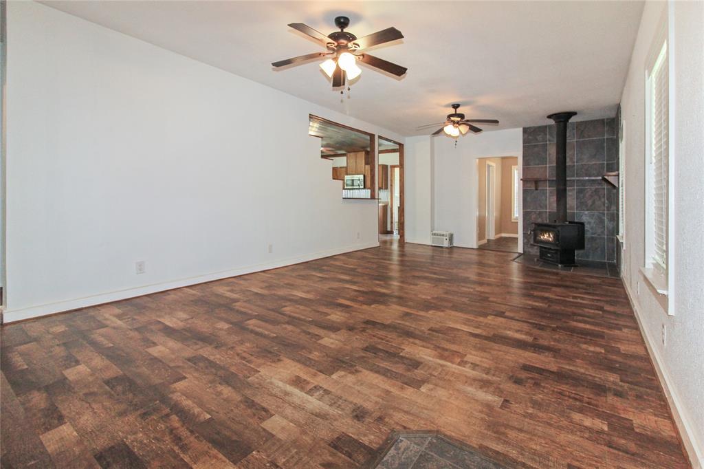 455 Hughes Cemetery Road Italy, TX 76651 - Photo 24 of 40 a view of empty room with wooden floor and fan
