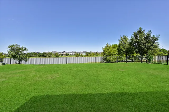a view of a field with tree in the background