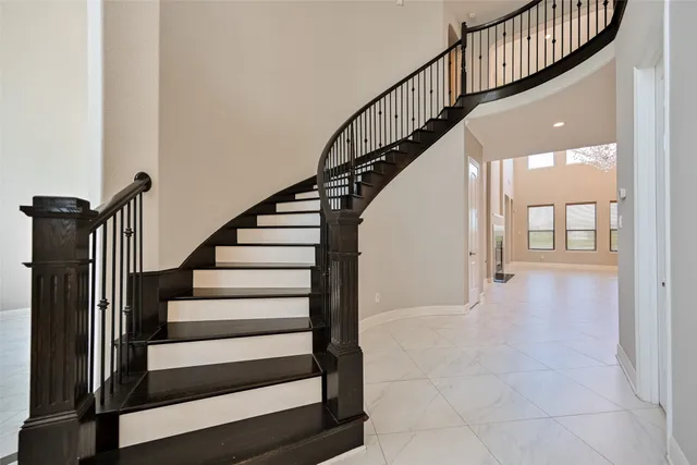 a view of staircase with wooden floor and a window