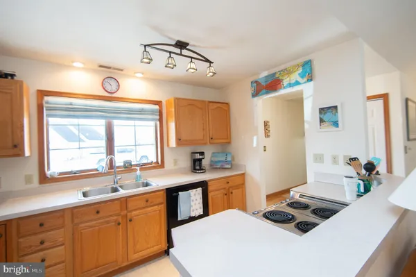 a kitchen that has a sink and a stove in it
