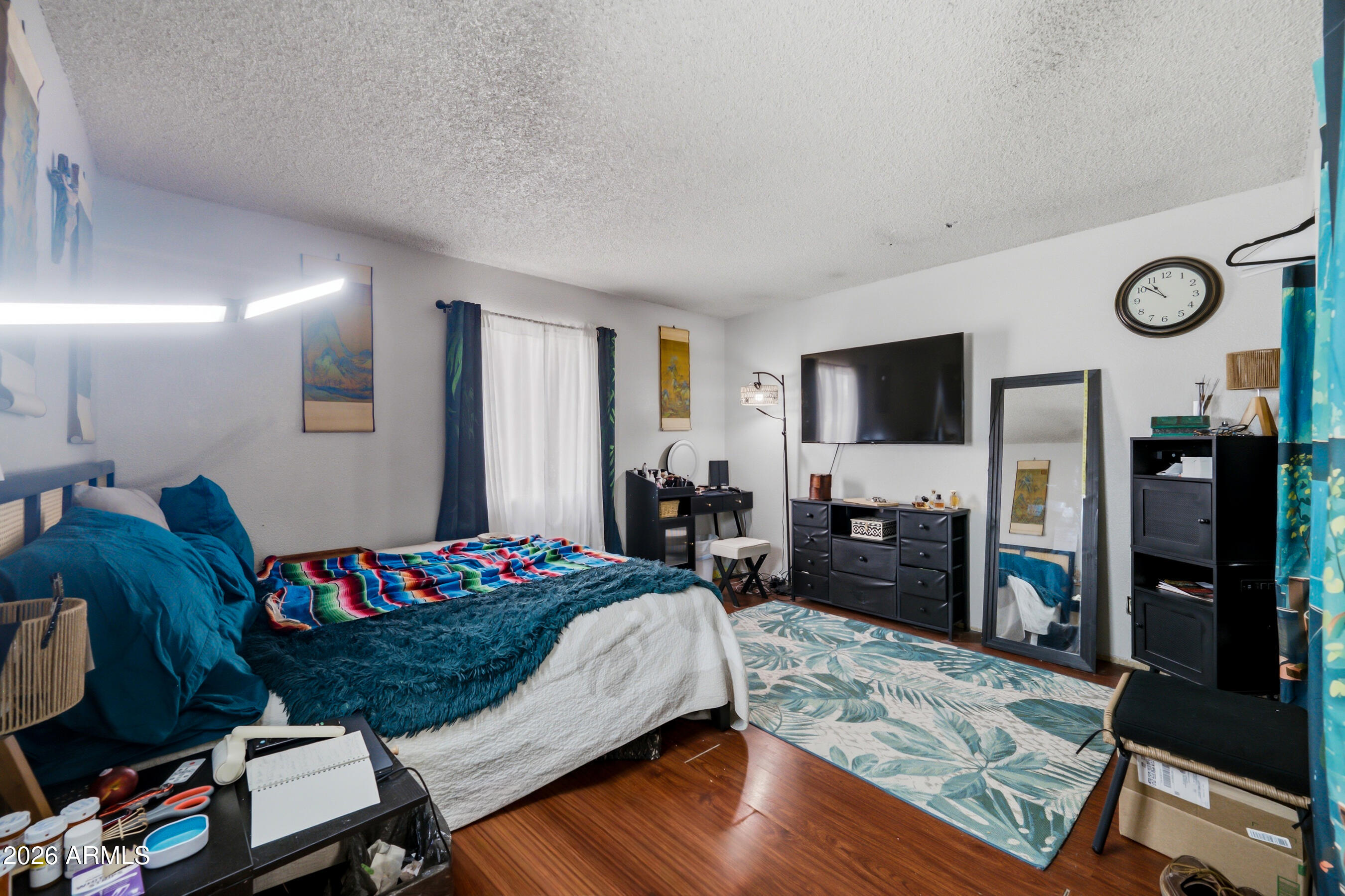 1051 South Dobson Road, Unit 187 Mesa, AZ 85202 - Photo 13 of 18 a bedroom with a bed and a flat screen television