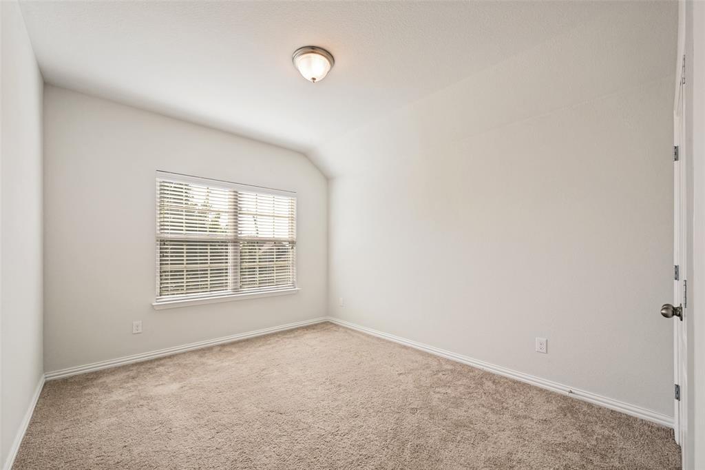 15725 Preble Road Fort Worth, TX 76177 - Photo 19 of 25 Neutral tone wall paint, vaulted ceiling, single window with blinds, carpet flooring, and flush mount lighting
