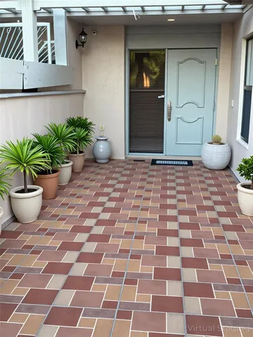 a view of a brick house with potted plants