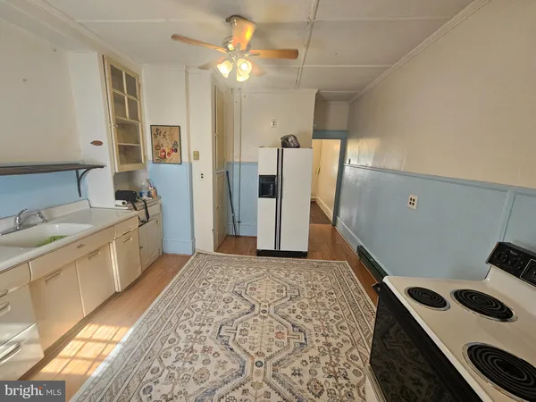 a bathroom with a sink a toilet a mirror and shower