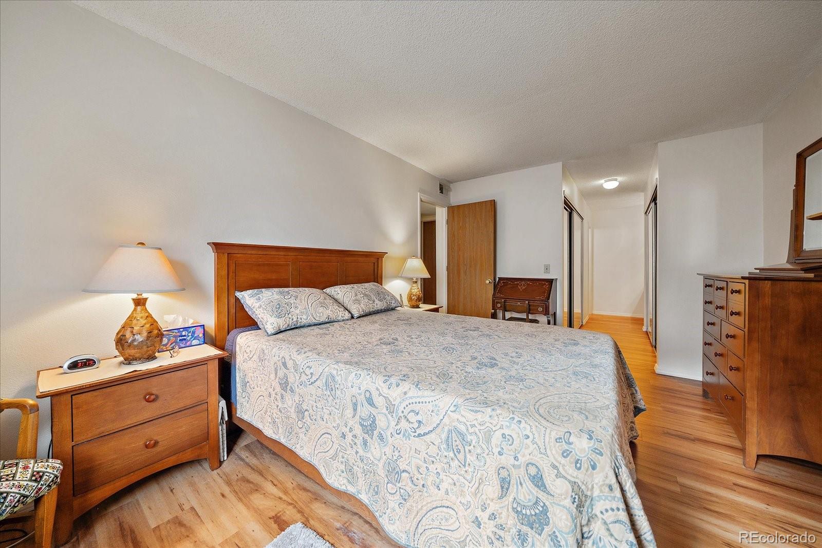 471 South Kalispell Way, Unit 101 Aurora, CO 80017 - Photo 13 of 27 a bed room with a bed and a dresser