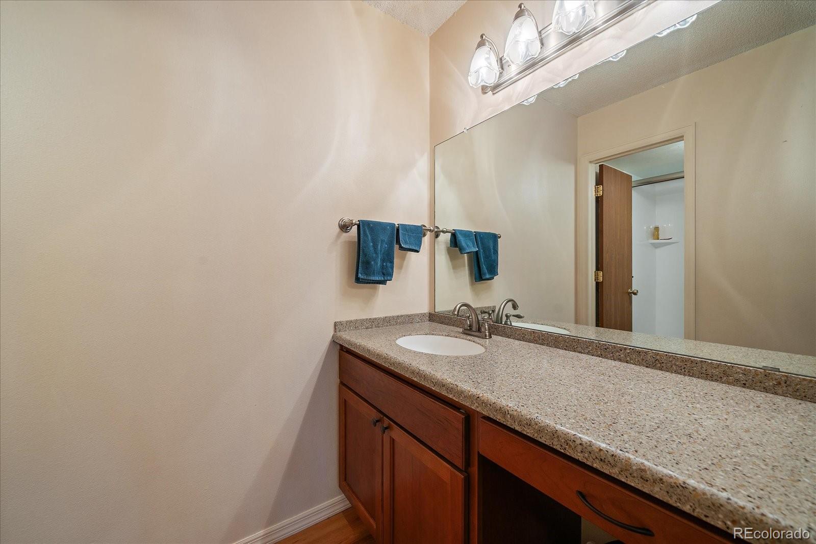 471 South Kalispell Way, Unit 101 Aurora, CO 80017 - Photo 14 of 27 a bathroom with a sink and a mirror