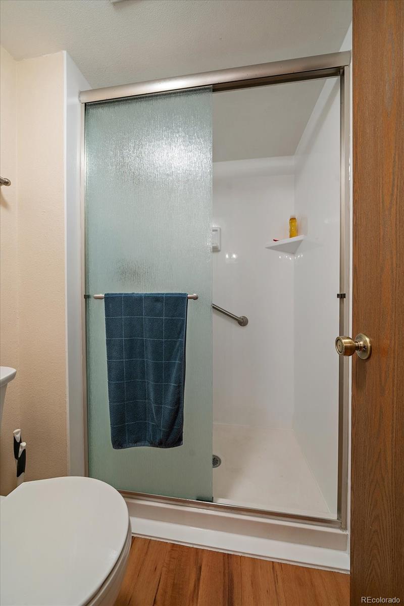 471 South Kalispell Way, Unit 101 Aurora, CO 80017 - Photo 15 of 27 a bathroom with a bathtub and a shower