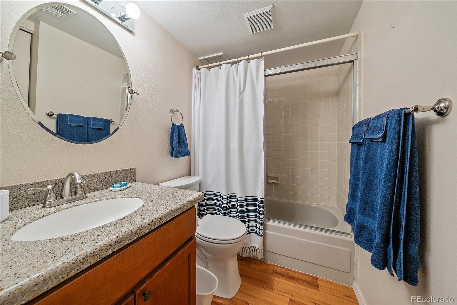 471 South Kalispell Way, Unit 101 Aurora, CO 80017 - Photo 18 of 27 a bathroom with a granite countertop sink toilet and shower