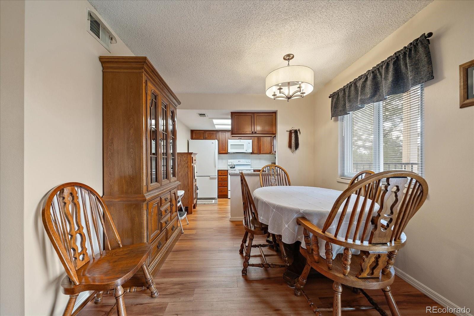 471 South Kalispell Way, Unit 101 Aurora, CO 80017 - Photo 8 of 27 a view of a dining room with furniture and a chandelier
