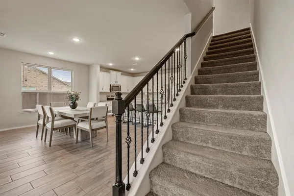 a dining room with furniture wooden floor and windows