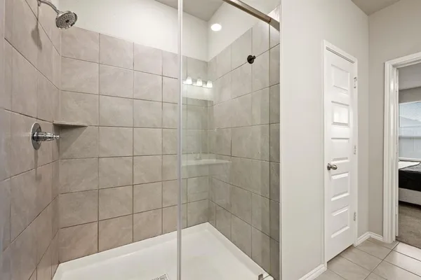 a bathroom with a bathtub and shower
