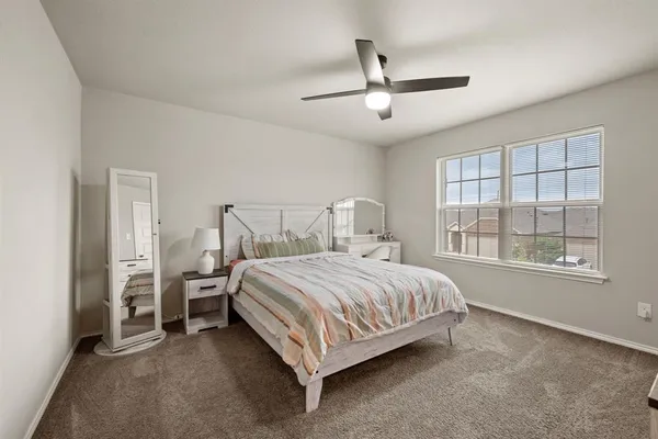 a bed sitting in a bedroom next to a window