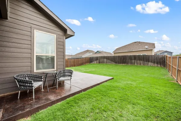 a view of a house with backyard porch and sitting area