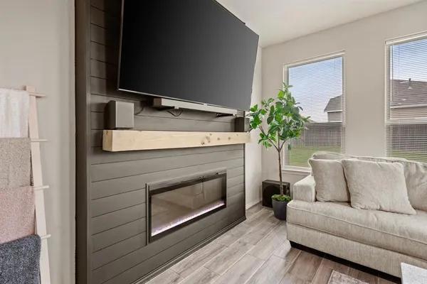 a living room with a fireplace furniture and a potted plant
