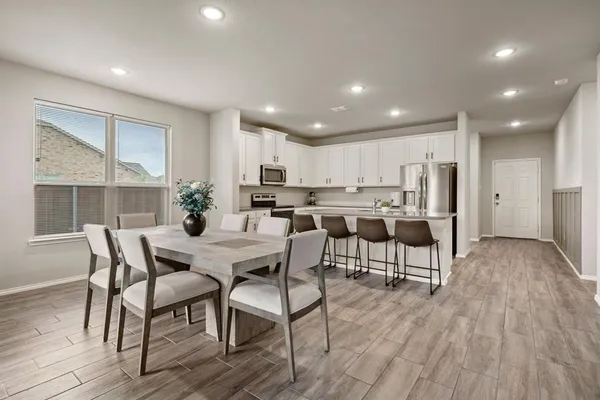 a view of a dining room with furniture and wooden floor