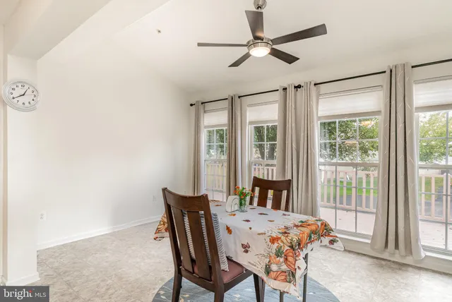 a living room with furniture a dining table and chairs with wooden floor