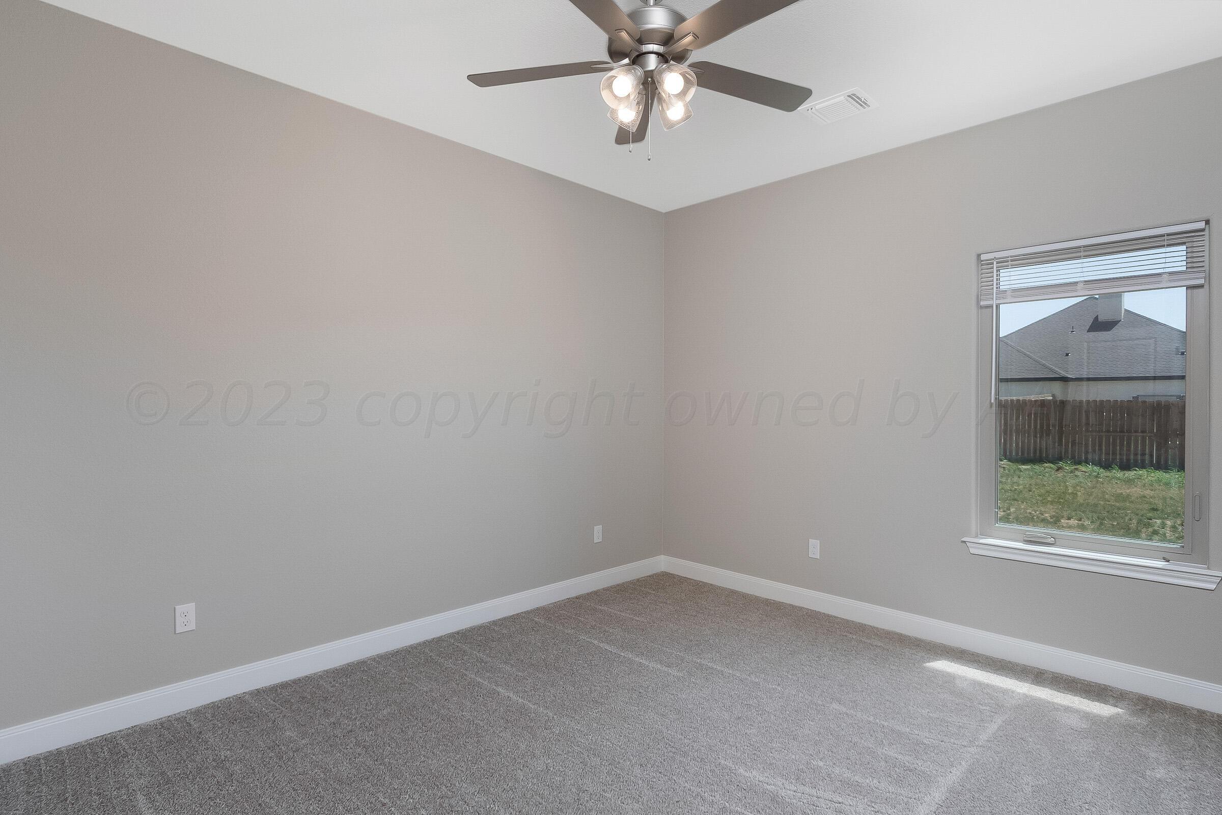 9289 Clinton Glen Road Amarillo, TX 79119 - Photo 17 of 27 an empty room with a window and a fan
