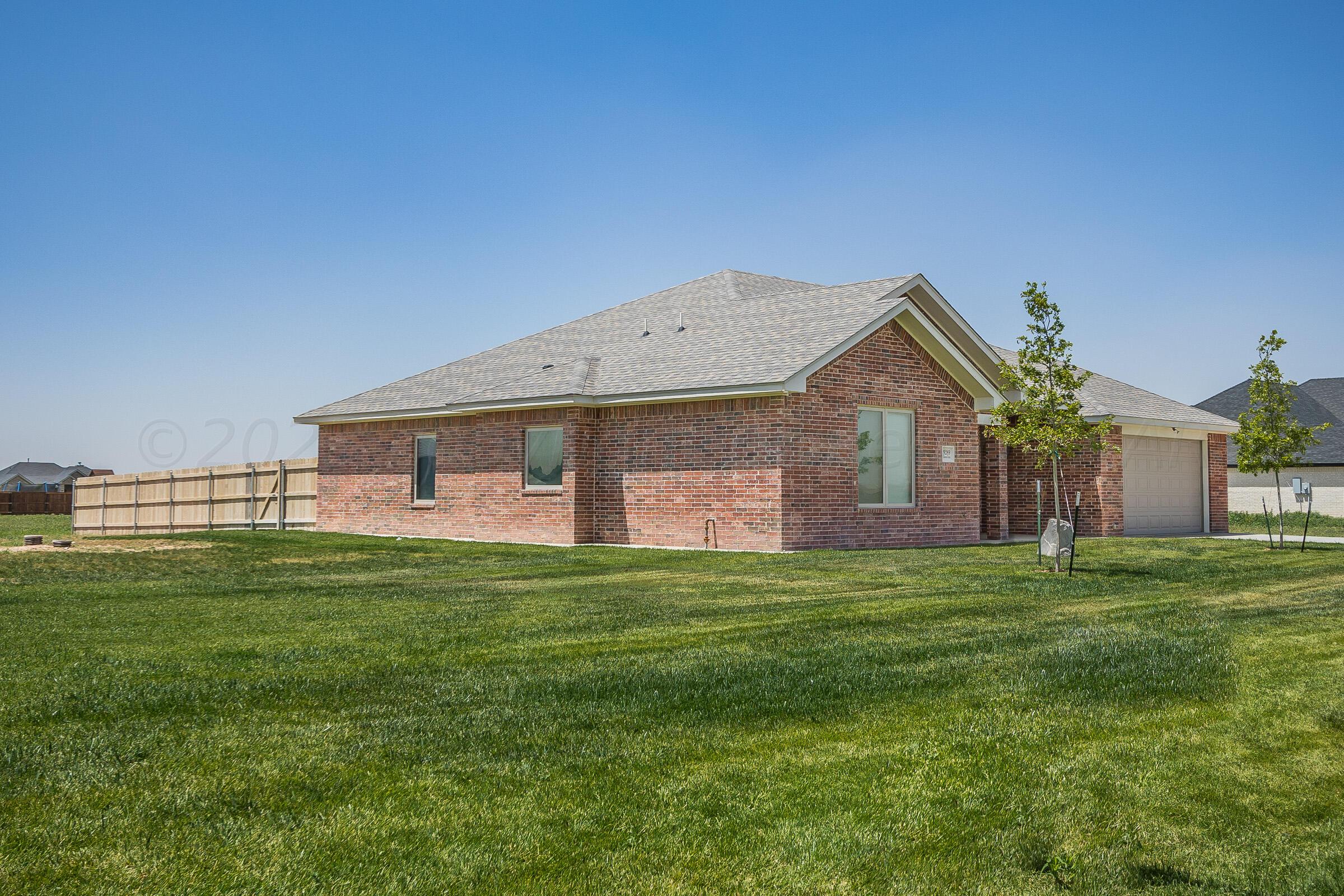 9289 Clinton Glen Road Amarillo, TX 79119 - Photo 27 of 27 a front view of a house with a garden
