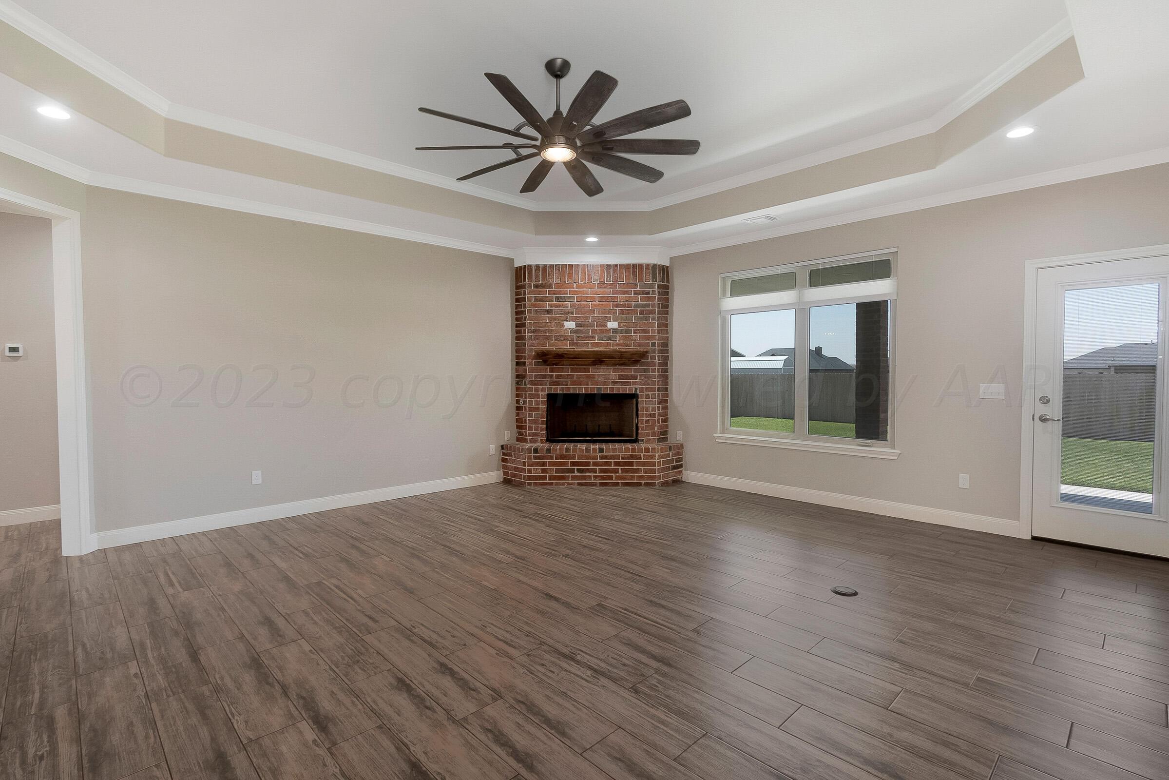 9289 Clinton Glen Road Amarillo, TX 79119 - Photo 4 of 27 a view of an empty room with wooden floor and a window