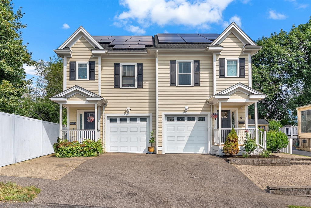 21 Crescent Road, Unit 21 Needham, MA 02494 - Photo 1 of 1 a front view of a house with a yard and garage
